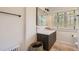 Well-lit bathroom featuring a modern vanity, large mirror, and classic radiator at 785 Fillmore St, Denver, CO 80206