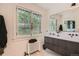 Bright bathroom with a modern vanity, large mirror, and a charming window with natural light at 785 Fillmore St, Denver, CO 80206