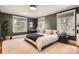 Relaxing bedroom featuring neutral tones, plush rug, and plenty of natural light from the large windows at 785 Fillmore St, Denver, CO 80206