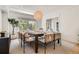Bright dining room with a wooden table, stylish chairs, and a large window, perfect for Gathering dinners at 785 Fillmore St, Denver, CO 80206