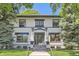 Charming home with black trim, stone stairs, and lush landscaping at 785 Fillmore St, Denver, CO 80206