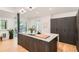 Bright and modern kitchen with a large island, dark cabinets, and a seamless transition to outdoor space at 785 Fillmore St, Denver, CO 80206