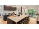 Contemporary kitchen featuring a large center island with seating, stainless steel appliances, and abundant counter space at 785 Fillmore St, Denver, CO 80206