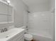 Bathroom featuring neutral walls and a shower-tub combo with modern fixtures at 3398 Wadsworth Blvd, Wheat Ridge, CO 80033