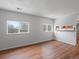 Bright living room with wood floors and natural light from two large windows at 3398 Wadsworth Blvd, Wheat Ridge, CO 80033