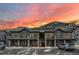 Condo's exterior at sunset offers stone accents, dark wood, balconies, and stunning mountain vistas at 2152 Bighorn Rd # 103, Georgetown, CO 80444