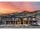 Stunning mountain views with condo's exterior featuring stone pillars, balconies and dark wood facade at sunset at 2152 Bighorn Rd # 103, Georgetown, CO 80444