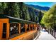 Exterior shot of Georgetown Loop Railroad passenger car with passengers alongside a mountain at 2152 Bighorn Rd # 103, Georgetown, CO 80444