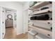 Hallway showing wood-style floors, shelving, and access to the bedroom and bathroom at 2152 Bighorn Rd # 103, Georgetown, CO 80444