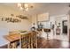 Inviting dining area featuring hardwood floors, a stylish light fixture, and seamless access to the kitchen at 9747 W Cornell Pl, Lakewood, CO 80227