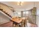 Dining room with table set, stairs and stone accent wall at 9747 W Cornell Pl, Lakewood, CO 80227