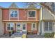 Charming townhouse with a red and beige exterior and well-maintained landscaping at 9747 W Cornell Pl, Lakewood, CO 80227