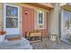 Close-up of front door with sidelight, planters and landscaping at 9747 W Cornell Pl, Lakewood, CO 80227