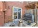 Cozy outdoor patio with chairs, grill, and sliding glass door entrance at 9747 W Cornell Pl, Lakewood, CO 80227