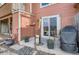 Outdoor patio area with grill, patio furniture, and adjacent storage at 9747 W Cornell Pl, Lakewood, CO 80227