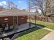 Well-manicured backyard with lush green grass, inviting covered patio and seating area at 5185 N Meade Street St, Denver, CO 80221