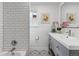Updated bathroom featuring patterned tile floor, subway tiled shower and updated vanity at 5185 N Meade Street St, Denver, CO 80221