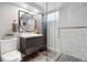 Modern bathroom featuring a sleek vanity, stylish mirror, and glass-enclosed shower with tiled walls at 5185 N Meade Street St, Denver, CO 80221