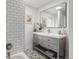Updated bathroom featuring patterned tile floor, subway tiled shower and updated vanity at 5185 N Meade Street St, Denver, CO 80221