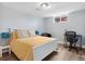 Comfortable bedroom features wood floors, white trim and window, plus desk and chair at 5185 N Meade Street St, Denver, CO 80221