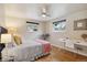 Bedroom featuring wood floors, neutral walls and bed with decorative pillows and blankets at 5185 N Meade Street St, Denver, CO 80221