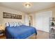 Bedroom featuring hardwood floors, a bed with blue comforter, a closet and natural lighting at 5185 N Meade Street St, Denver, CO 80221
