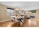Open concept dining and living area featuring hardwood floors and bright neutral walls at 5185 N Meade Street St, Denver, CO 80221