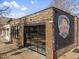 Unique brick building with big glass window, inviting patio, and distinctive signage at 5185 N Meade Street St, Denver, CO 80221