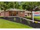 Charming brick home with a cozy front porch and mature trees in a well-manicured front yard at 5185 N Meade Street St, Denver, CO 80221
