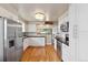 Bright kitchen featuring white cabinets, stainless steel appliances, hardwood floors and contrasting dark countertops at 5185 N Meade Street St, Denver, CO 80221