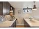 Modern kitchenette with tan countertops, mosaic backsplash, and stainless steel sink at 5185 N Meade Street St, Denver, CO 80221