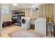 Functional laundry room with washer, dryer, sink, shelves, and storage options at 5185 N Meade Street St, Denver, CO 80221