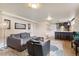 Basement living area featuring a modern kitchenette, area rug, and comfortable seating at 5185 N Meade Street St, Denver, CO 80221