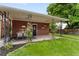 Charming covered patio with ample seating, lush greenery, and garden beds at 5185 N Meade Street St, Denver, CO 80221