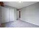 Neutral bedroom featuring plush carpeting, a double-door closet, and fresh gray paint at 1365 Waxwing Ave, Brighton, CO 80601