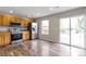 Bright kitchen featuring wood cabinets, stainless steel appliances, and sliding door access to outdoor deck at 1365 Waxwing Ave, Brighton, CO 80601
