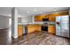 Modern kitchen with wood cabinets, granite countertops, stainless steel appliances, and hardwood floors at 1365 Waxwing Ave, Brighton, CO 80601