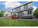 Spacious backyard featuring a deck, with lush grass and a gray two story home at 517 Sylvestor Trl, Highlands Ranch, CO 80129