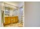 Bathroom with double vanity, wood cabinets and a shower behind decorative curtains at 517 Sylvestor Trl, Highlands Ranch, CO 80129