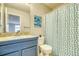 Compact bathroom featuring a blue vanity and a shower with a fun, patterned curtain at 517 Sylvestor Trl, Highlands Ranch, CO 80129