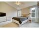 Bright bedroom featuring neutral walls, ceiling fan and two windows with natural light at 517 Sylvestor Trl, Highlands Ranch, CO 80129