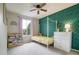 Bright bedroom featuring wallpaper accent wall, shelving, and a ceiling fan at 517 Sylvestor Trl, Highlands Ranch, CO 80129