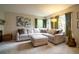 Bright living room featuring large sectional sofa, plush carpet and natural light at 517 Sylvestor Trl, Highlands Ranch, CO 80129
