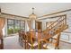 Formal dining room with large windows, elegant chandelier, and traditional wood furniture at 5106 S Kenton Way, Greenwood Village, CO 80111