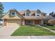 Charming two-story home with a well-manicured lawn and attached two car garage at 5106 S Kenton Way, Greenwood Village, CO 80111
