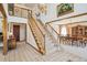 Grand foyer features high ceilings, chandelier, open staircase, and adjoining dining room at 5106 S Kenton Way, Greenwood Village, CO 80111
