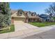 A charming house with a well-manicured lawn, a brick facade, and a spacious driveway at 5106 S Kenton Way, Greenwood Village, CO 80111