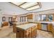 Spacious kitchen with a large island, light wood cabinets, and modern appliances at 5106 S Kenton Way, Greenwood Village, CO 80111
