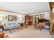 Bright living room with traditional furnishings, wood accents, and a view of the piano at 5106 S Kenton Way, Greenwood Village, CO 80111
