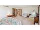 Spacious bedroom featuring a seating area and view of the staircase at 5106 S Kenton Way, Greenwood Village, CO 80111